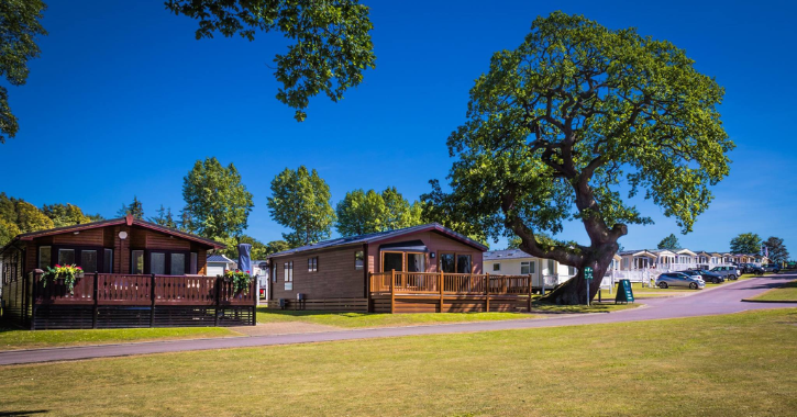 View of caravans at Witton Castle Country Park on a bright sunny day.